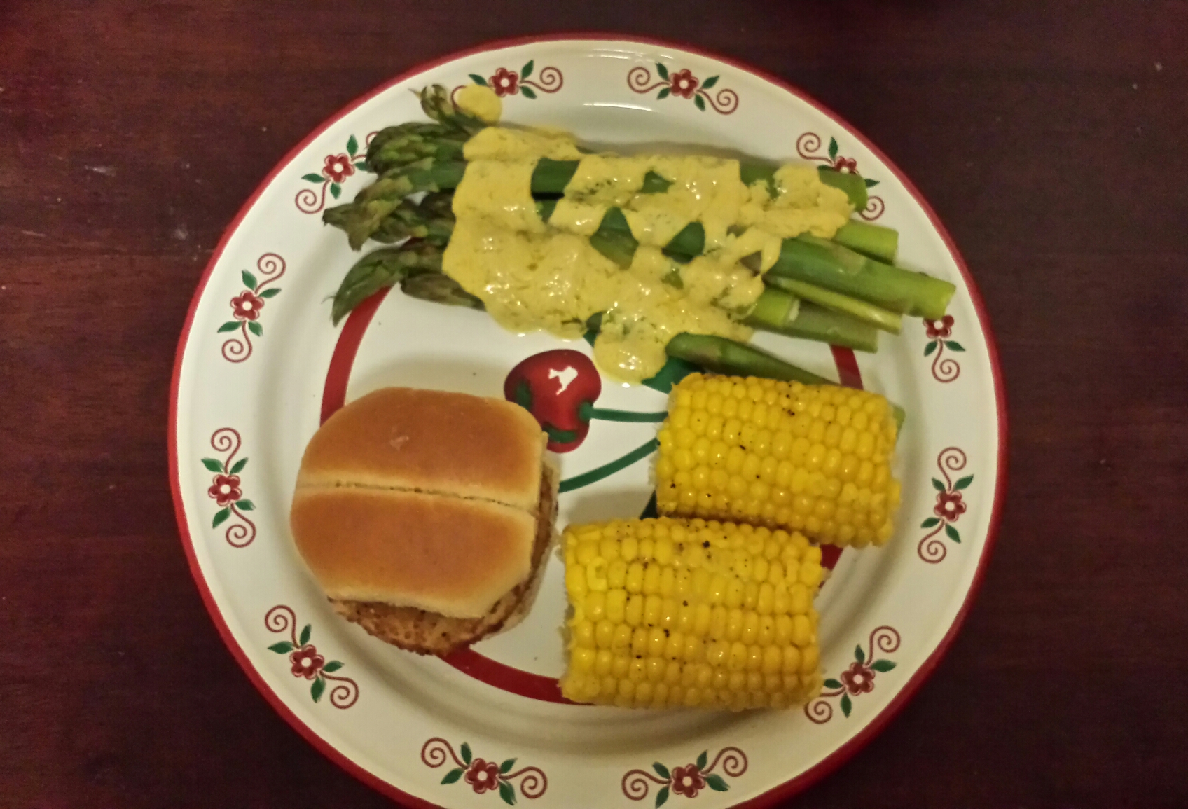 Asparagus with vegan hollandaise sauce, corn on the cob, and Gardein Chik'n Slider